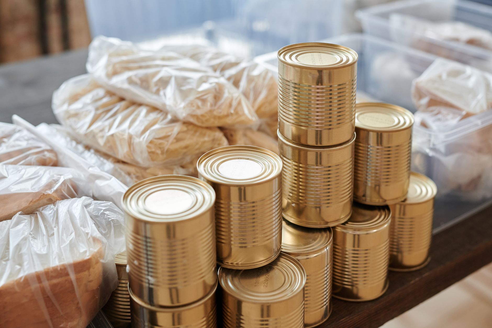 Rows of canned soup, vegetables, and meat on organized pantry shelves
