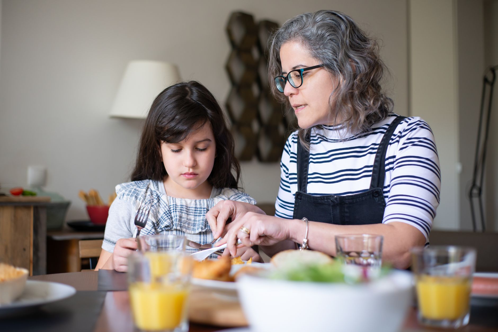 Family taste-testing their emergency food supplies at home before storing them.