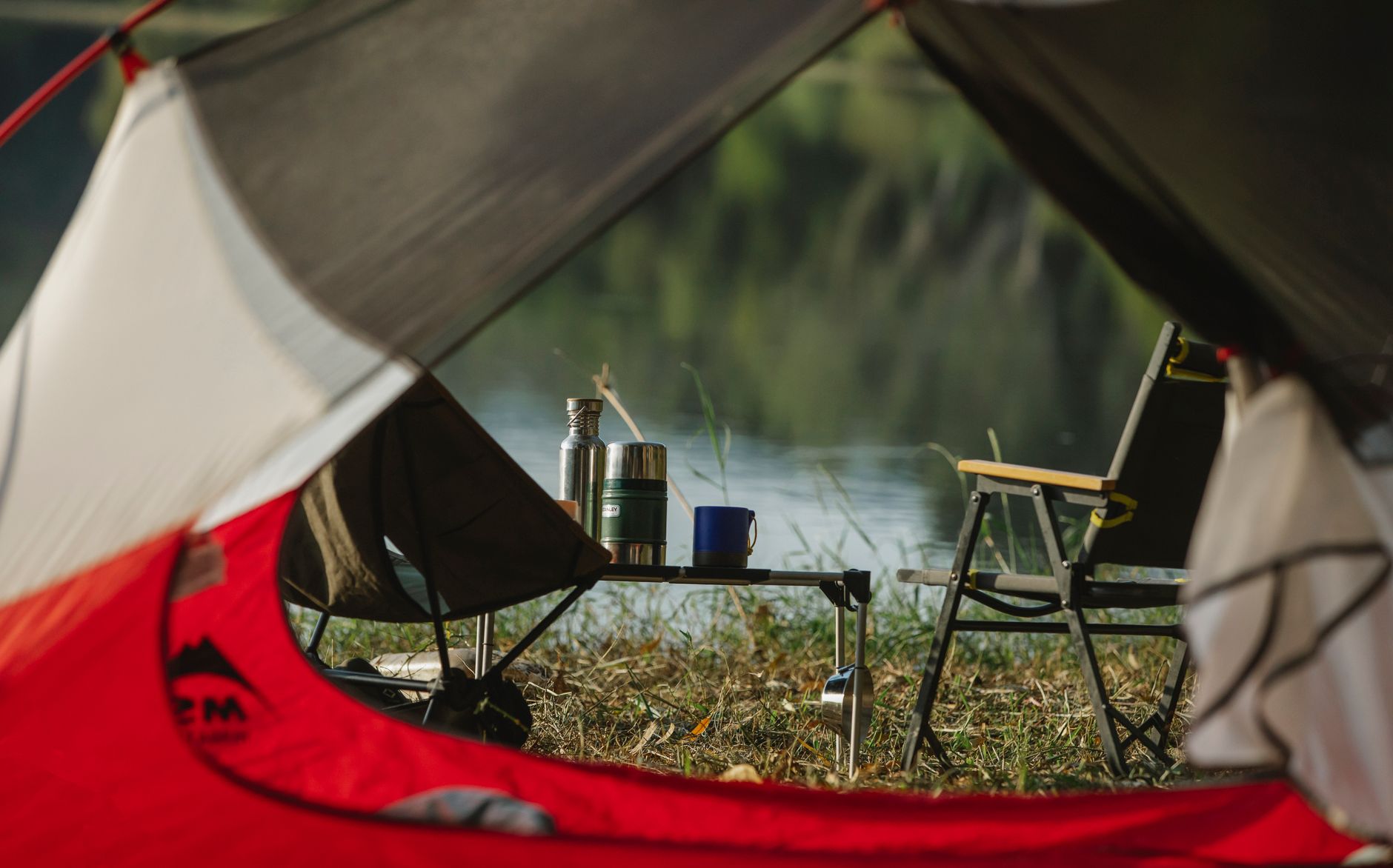 Jackery Explorer 5000 Plus portable power station beside a tent