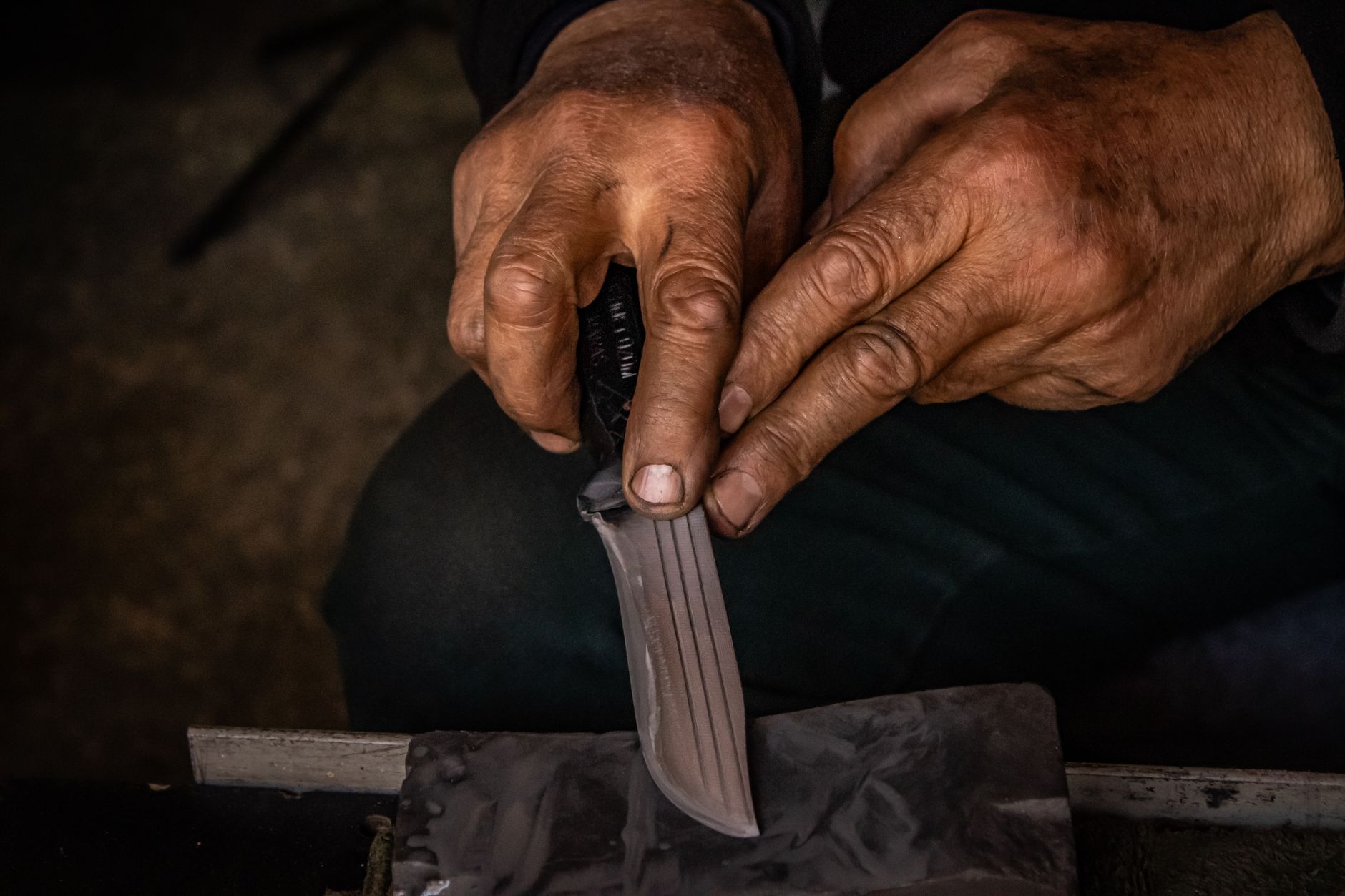 Benchmade Bugout ultralight folding knife in hand showing AXIS lock
