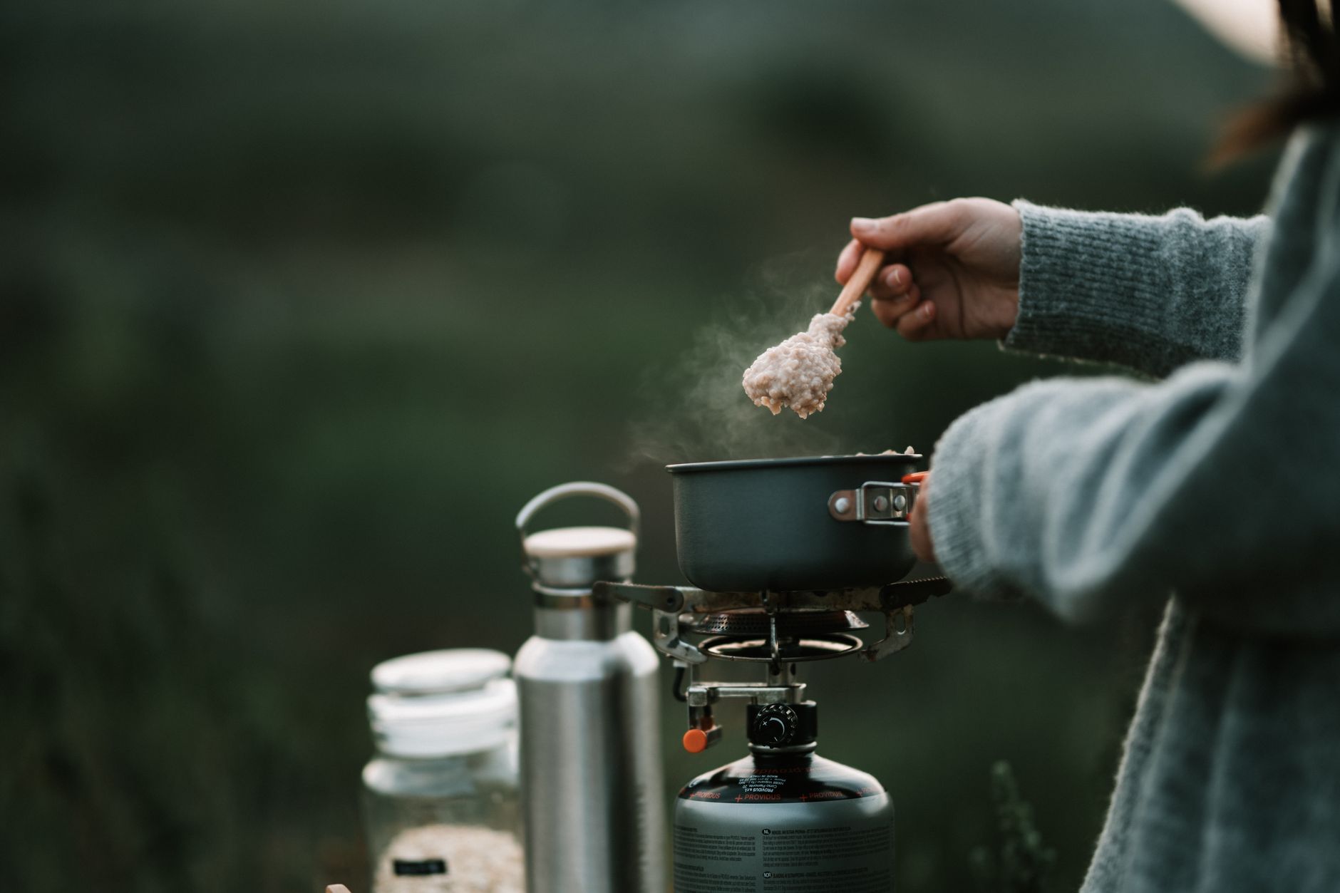 Freeze-dried meal pouches, energy bars, and a mess kit arranged for a bug out bag.