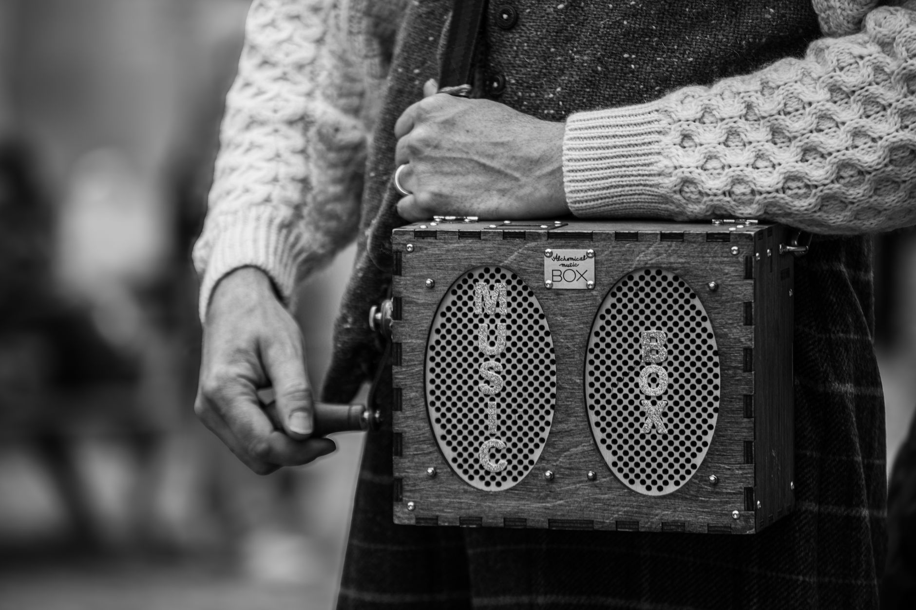 Hand-crank emergency radio, solar power bank, and signal mirror on a backpack.