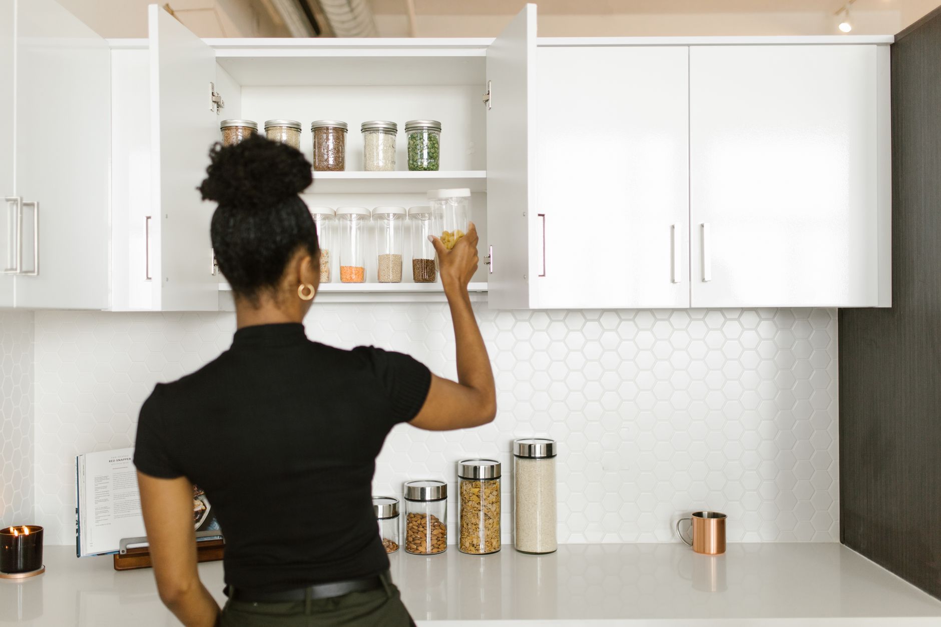 Organized shelves with canned goods, grains, and water containers for emergency food storage