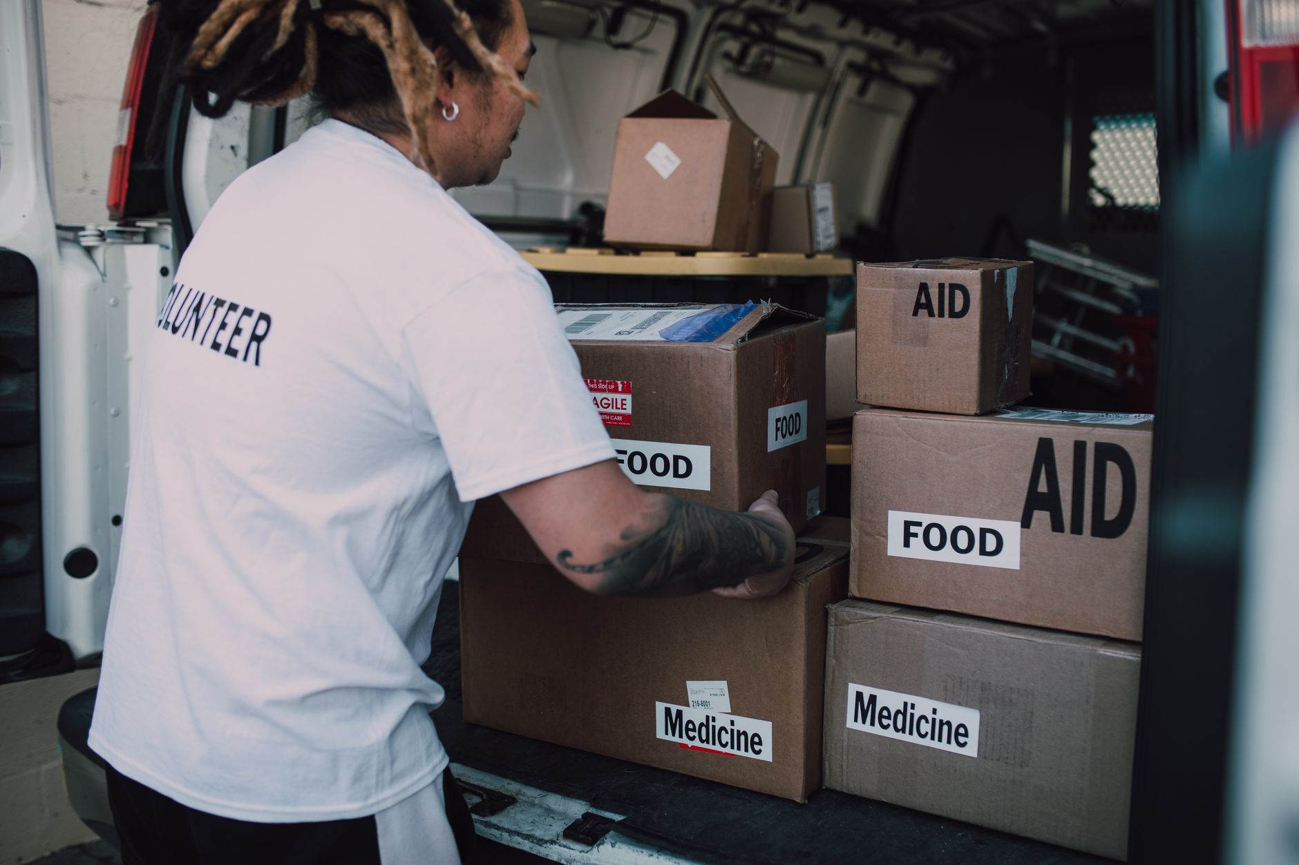 A family sorting boxes of non-perishable food for a two-week emergency supply