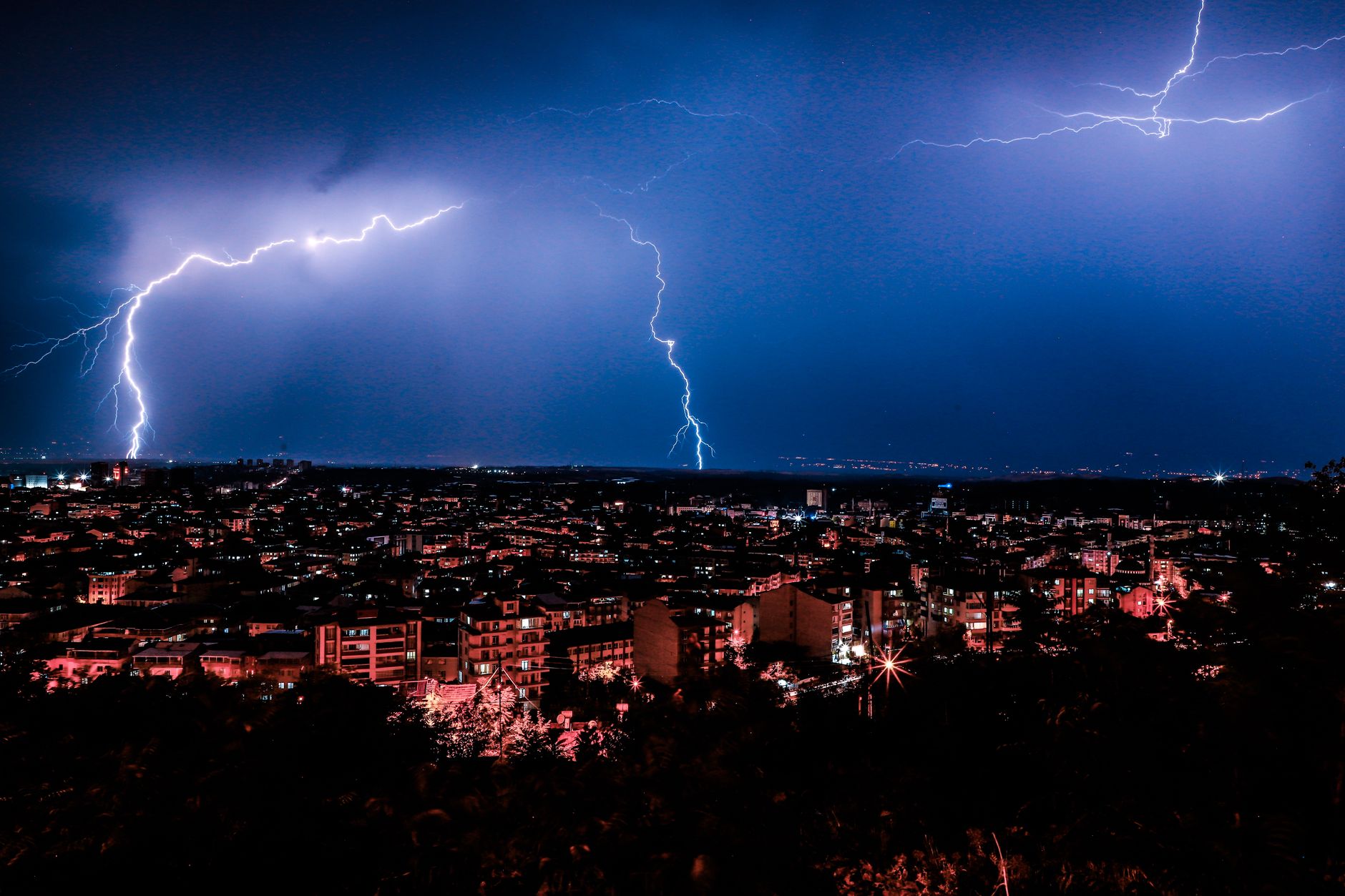 A city skyline completely dark during a prolonged grid failure
