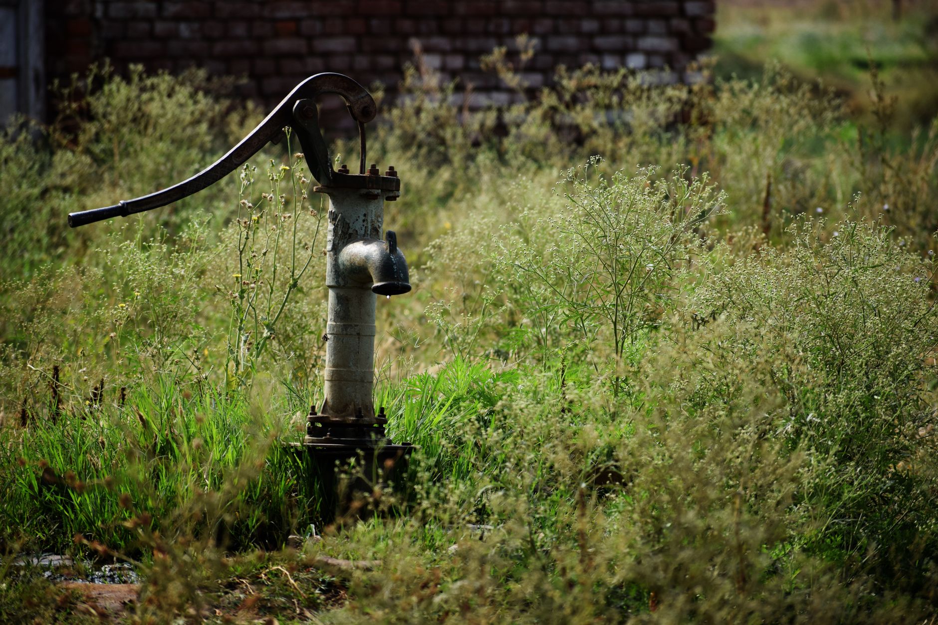 Hand pump drawing water from a well on an off-grid rural property