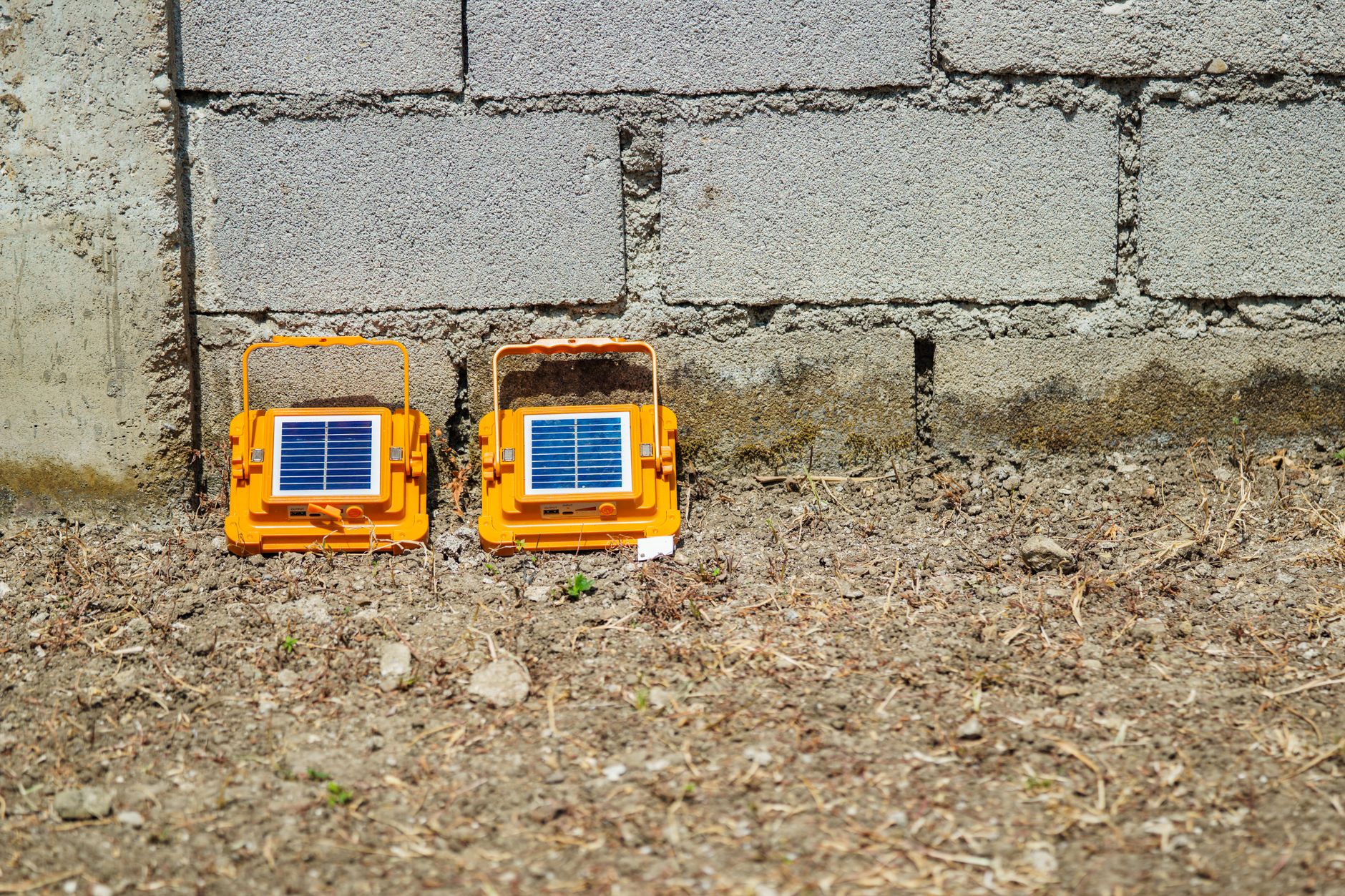 A portable solar generator powering a lamp in a dark living room