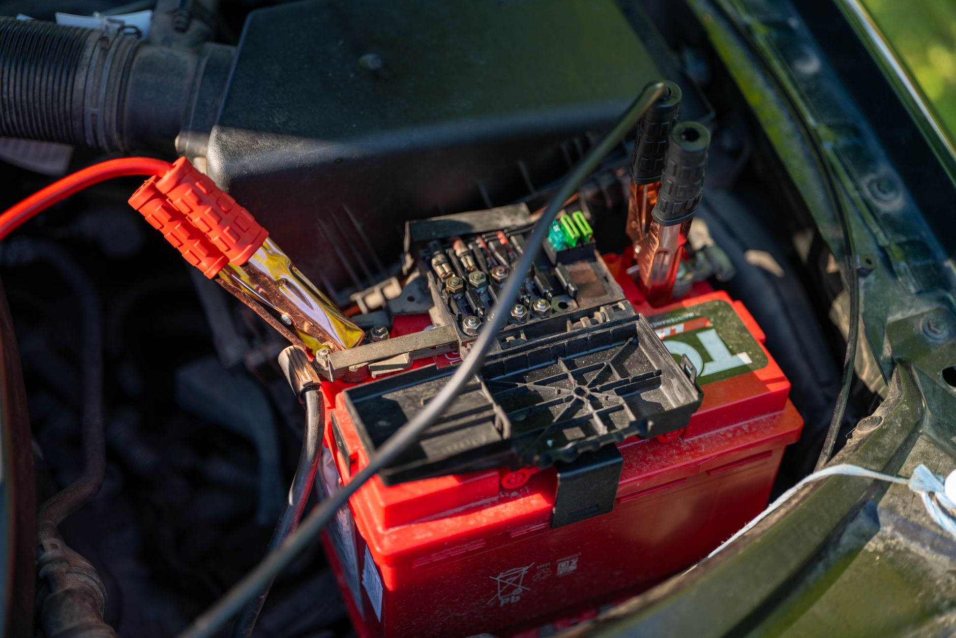 Insulated bottles and emergency food bars stored in a car trunk for winter preparedness
